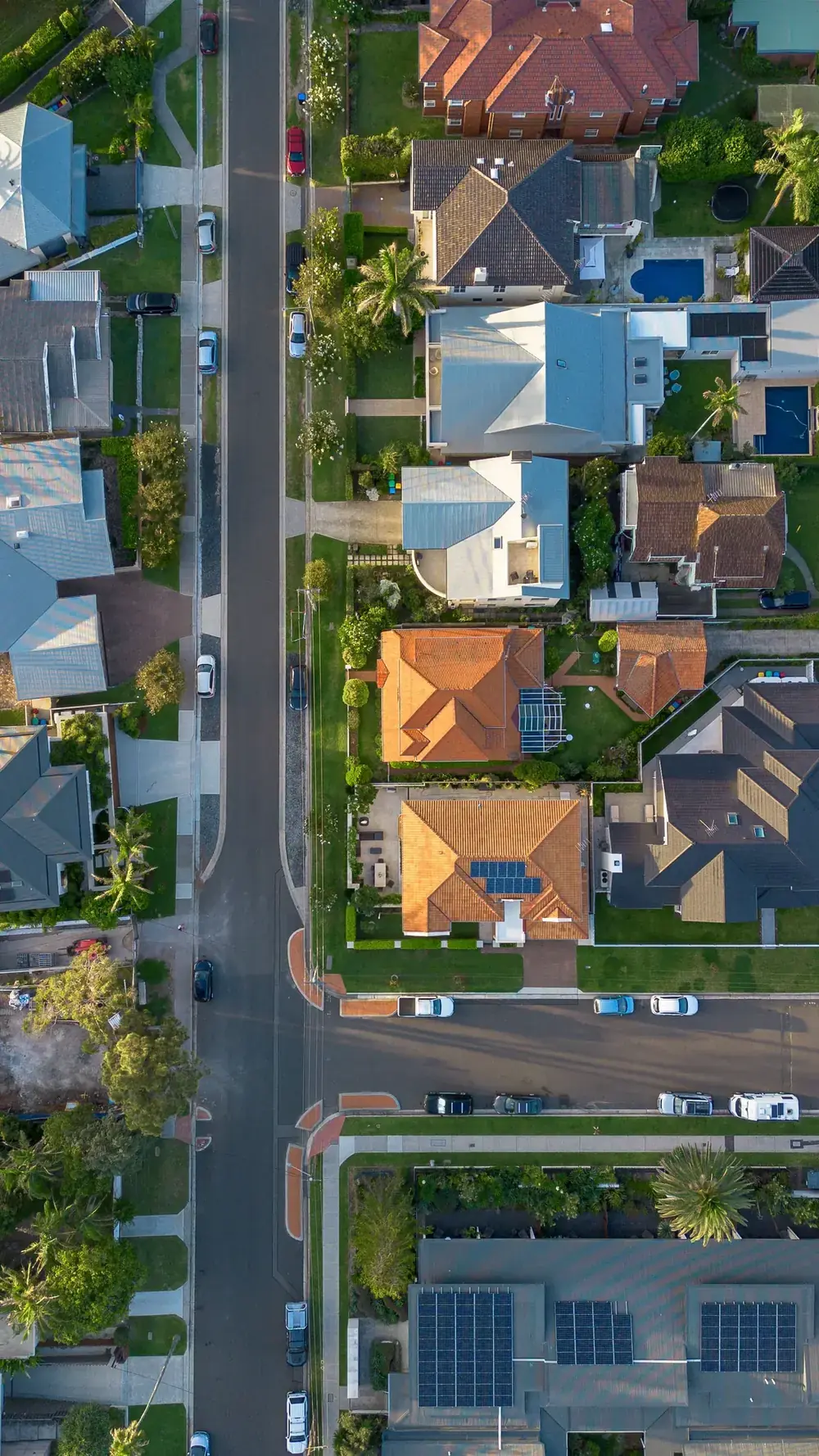 Aerial view of a residential neighbourhood street with detached homes